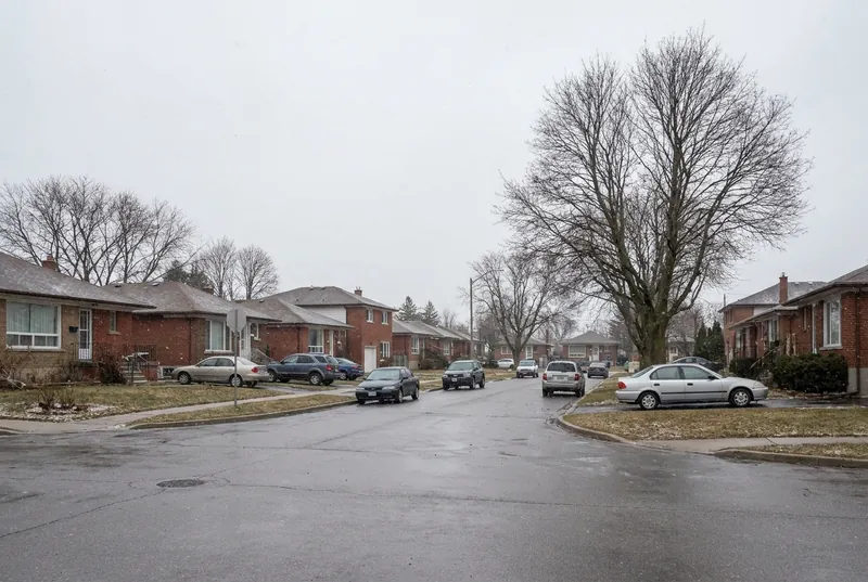A post-war brick bungalow street in Scarborough on a wet grey day.